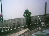 Blacksmith welding steel railings in place -  Camlachie Phase 5 Glasgow